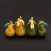 Four gold and green pear-shaped fruit keychain charms with glitter finish