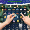 A collection of crystal gemstones arranged in a grid on a dark blue Advent calendar board.