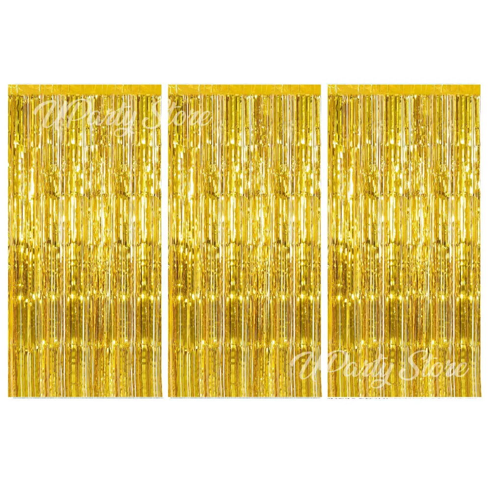 Three panels of shimmering gold metallic foil fringe curtains for party backdrop decor