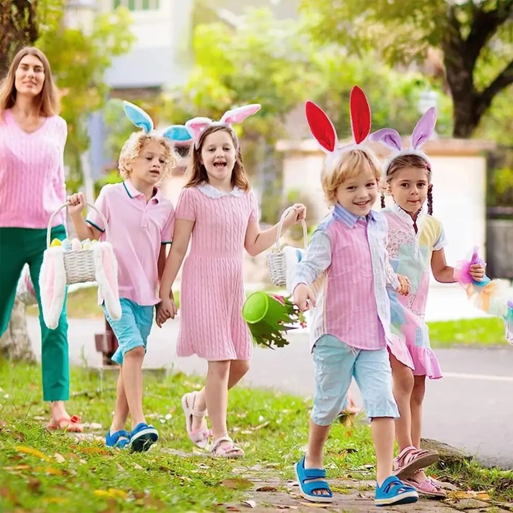Five children wearing colorful bunny ear headbands outdoors