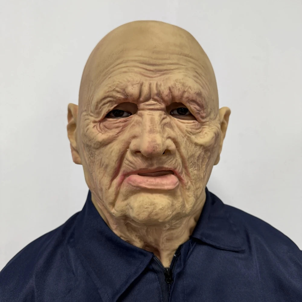 A realistic latex mask of an old man with wrinkled skin and a long neck, worn by a person in a dark blue shirt.