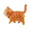 An orange 3D cartoon cat figurine used as a refrigerator magnet.