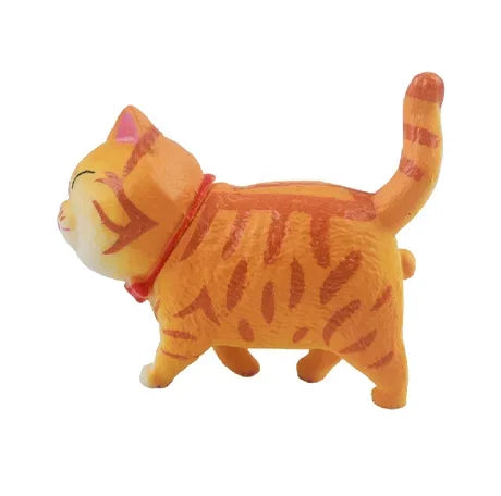 An orange 3D cartoon cat figurine used as a refrigerator magnet.