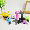 A collection of colorful robot joint models and toys including yellow, pink, and silver figures on a white surface.