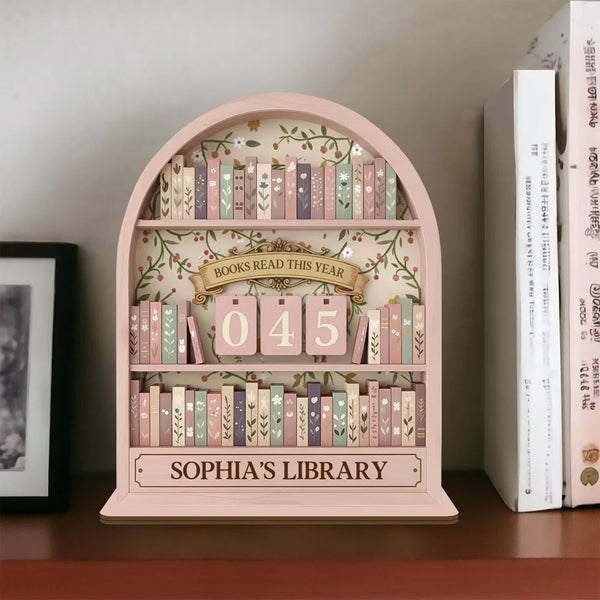 A pink wooden arched shelf displaying books and a sign that reads Books Read This Year 045 for Sophia's Library