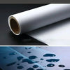 Roll of white material next to a close-up of blue liquid drops on a dark surface.