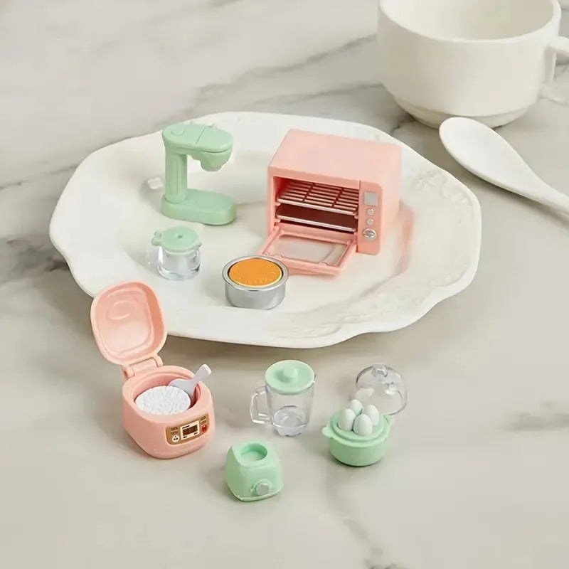 A set of pink and mint green realistic kitchen appliance dollhouse accessories including a grinder, mortar, and various small