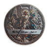 A commemorative coin featuring the Archangel Michael with wings and a sword, inscribed with the verse Jude 1:9.
