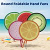 Round foldable hand fans featuring colorful fruit designs like lime, watermelon, and orange on a beach.