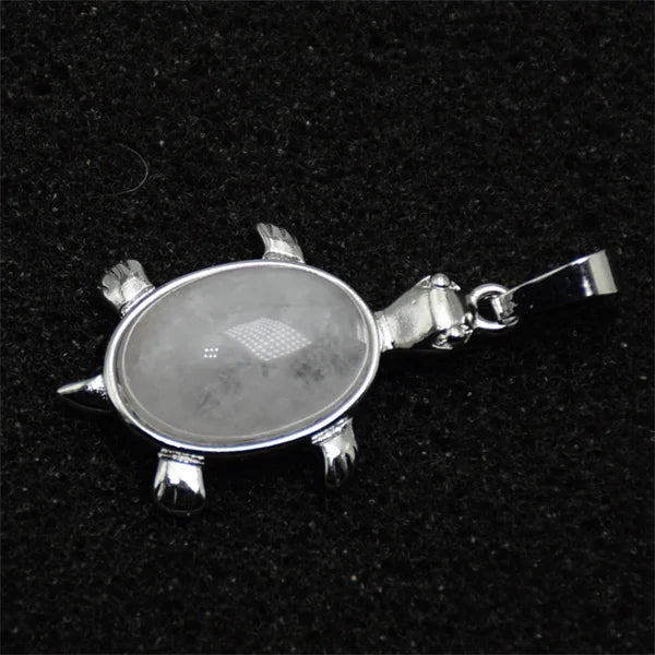 Silver pendant necklace featuring a polished, oval natural stone with small dark inclusions and animal-shaped charms.