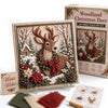 A framed Christmas 3D fabric poke art kit featuring a deer in a winter forest scene with pine and snow elements.