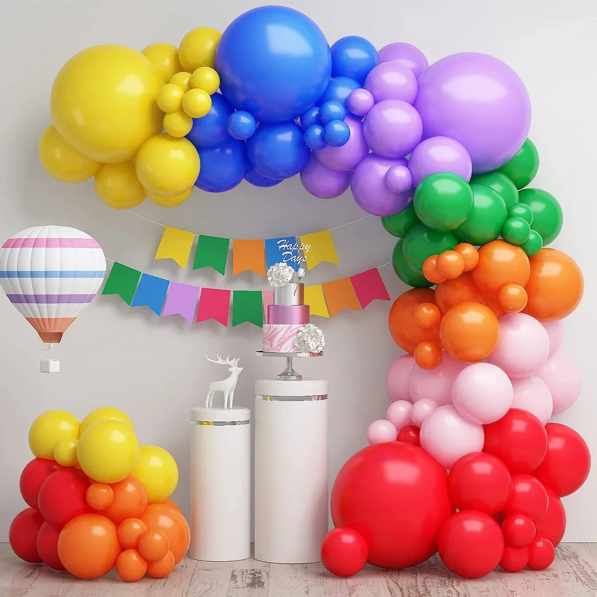 A colorful balloon garland arch kit featuring yellow, blue, purple, and green balloons for party decorations.