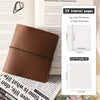 A brown faux leather photo album with a black strap and a cover featuring text.