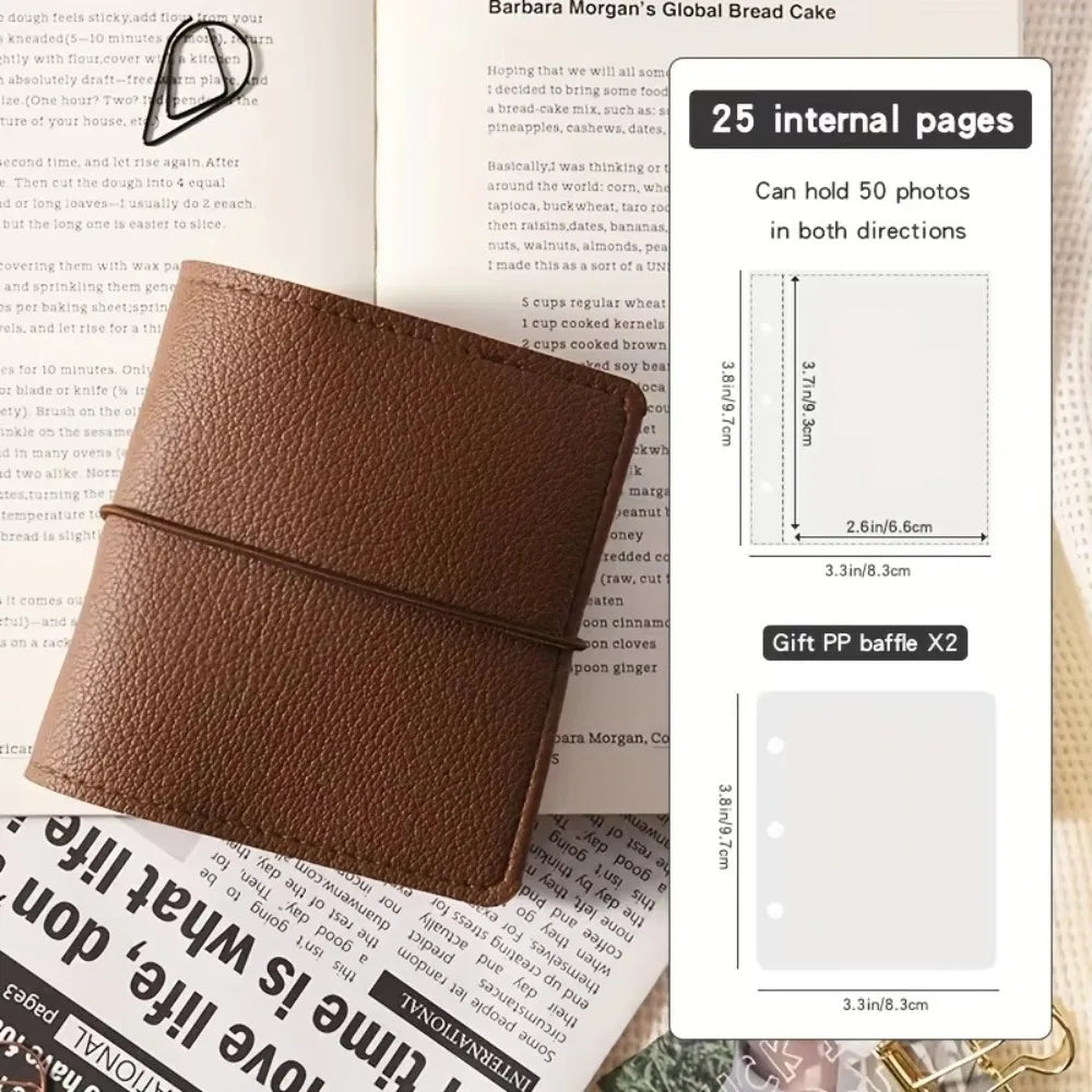 A brown faux leather photo album with a black strap and a cover featuring text.