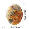 Oval natural stone bead with mottled amber, brown, and gray patterns.