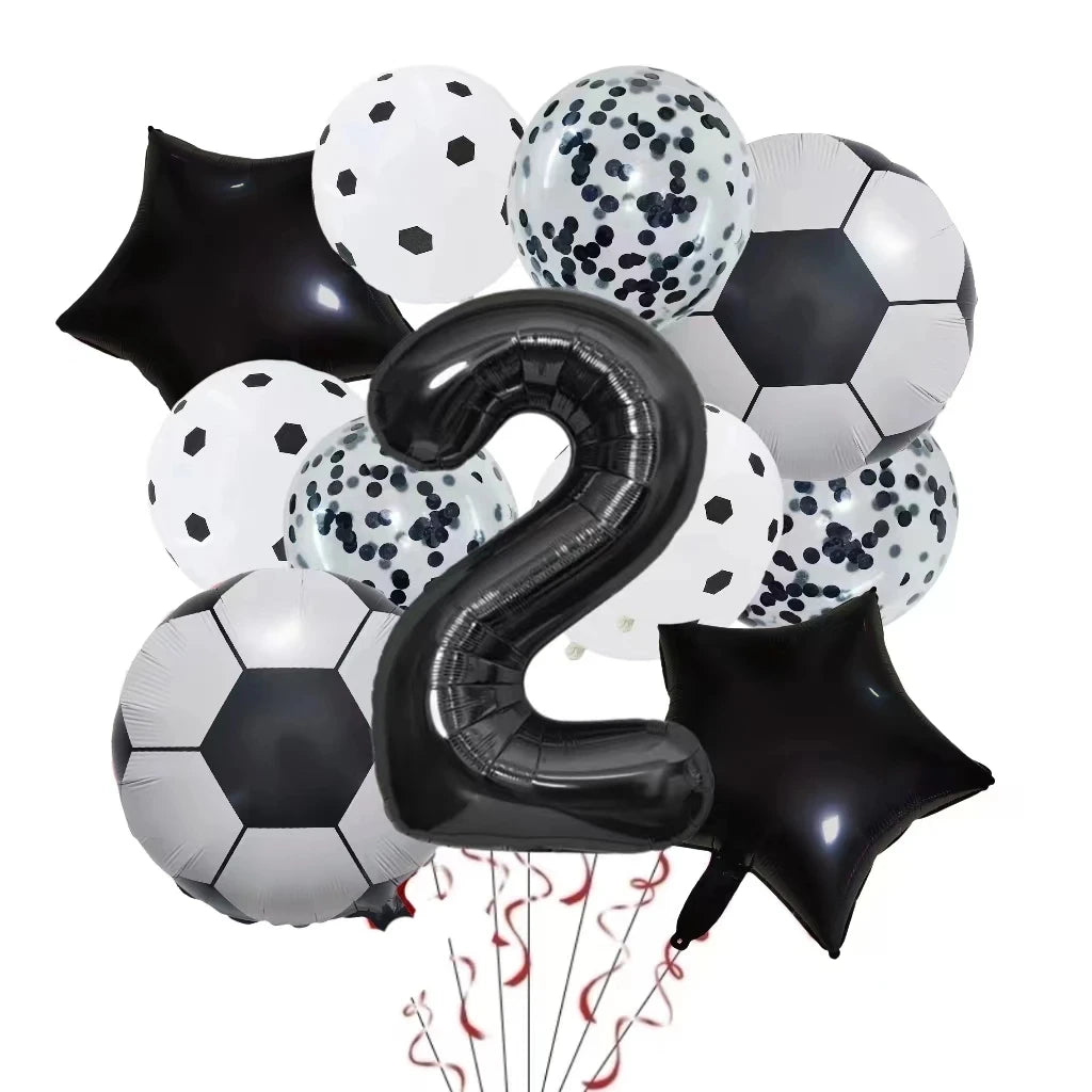 A set of black and white patterned football shaped helium foil balloons and a large black number two balloon for birthday dec