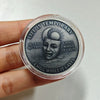 A clear coin with a dark engraving featuring a skull and sun, surrounded by text about life being temporary and chilling whil