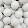 A close-up view of a large pack of white, spherical ocean balls for kids' play areas.