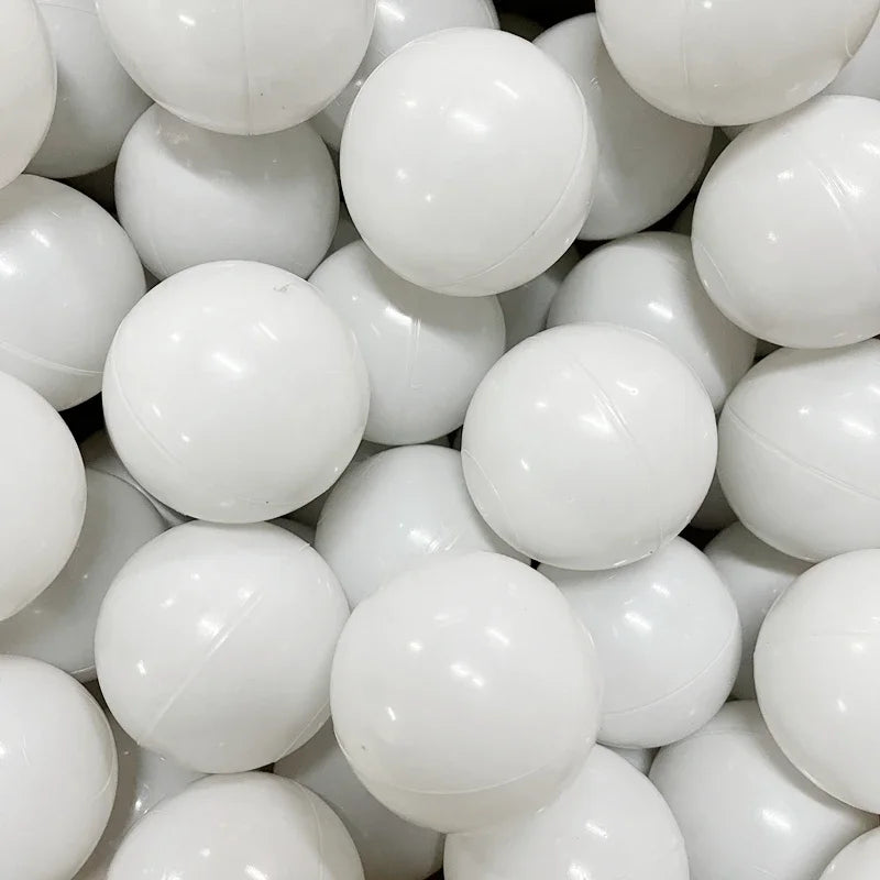 A close-up view of a large pack of white, spherical ocean balls for kids' play areas.