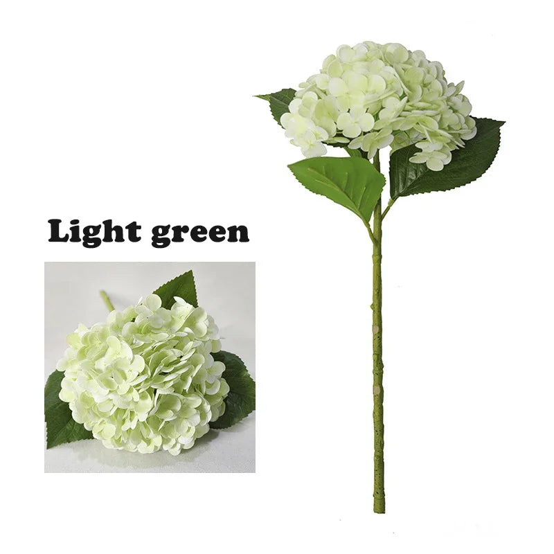 Light green artificial hydrangea flower on a stem with green leaves