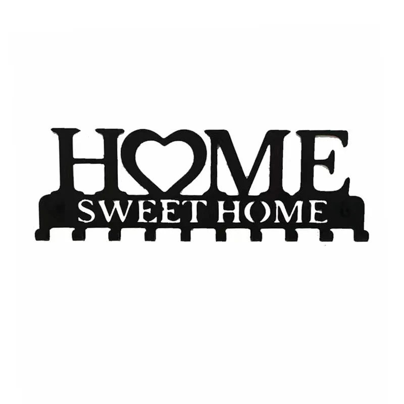 Black metal key holder with a heart shape and the words sweet home, featuring wall mounted hooks.