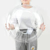 A person is holding a large, transparent inflatable balloon that is shaped like a bobo.