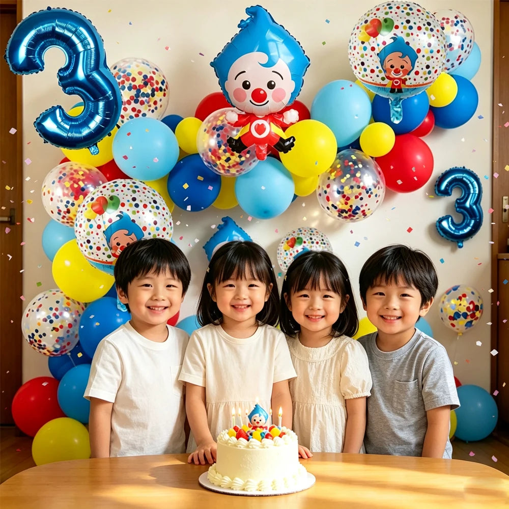 Four children posing in front of a wall decorated with large blue and yellow balloons and a cake.