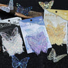 A collection of butterfly stickers in various colors including silver, purple, and gold on a dark background.