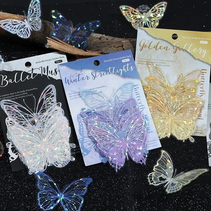 A collection of butterfly stickers in various colors including silver, purple, and gold on a dark background.