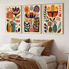 A set of three framed floral canvas prints featuring colorful Scandinavian folk art designs on a white wall.