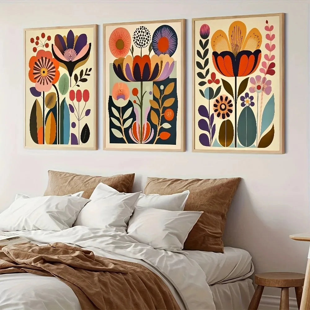 A set of three framed floral canvas prints featuring colorful Scandinavian folk art designs on a white wall.