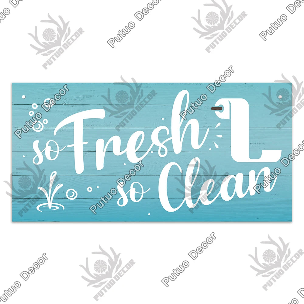 A rustic wooden toilet wall sign with white text that reads So Fresh L Clean
