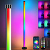 A tall, vertical RGB floor lamp displaying a full spectrum of light, with an accompanying smartphone and remote control.