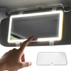 A hand is adjusting an LED car sun visor vanity mirror with adjustable straps.
