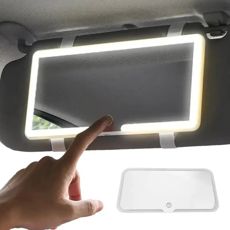 A hand is adjusting an LED car sun visor vanity mirror with adjustable straps.