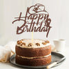 A brown glitter birthday cake topper shaped like a cowboy hat and text on a stack of chocolate cake.