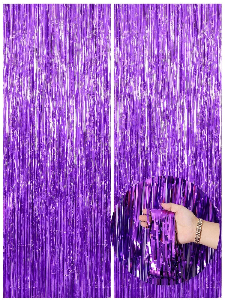 Two vertical panels of metallic purple foil fringe curtains with a hand touching the texture.