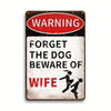 A vintage metal tin sign with a red warning oval and text that reads Forget the dog beware of wife