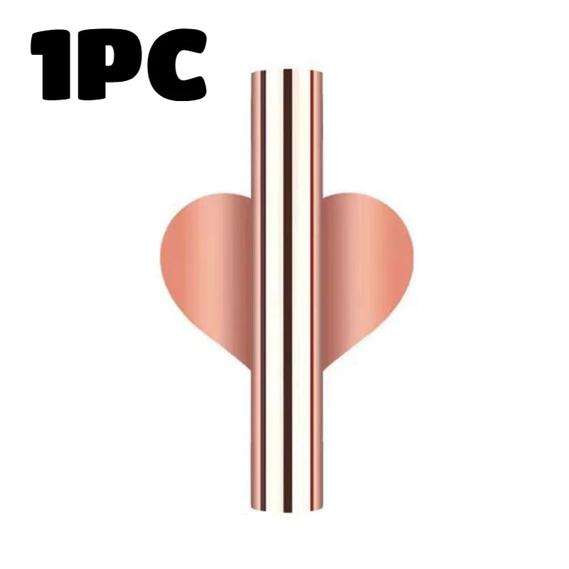 A modern wall-mounted flower vase featuring vertical stripes of rose gold and white.