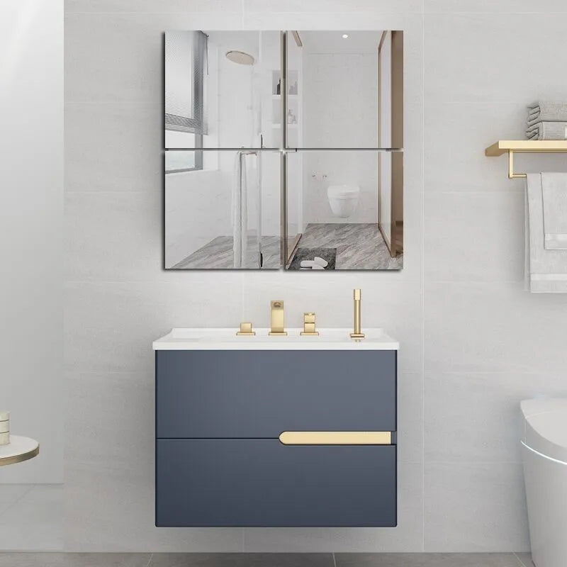 A modern bathroom featuring a glass shower enclosure and a floating vanity with a gold handle.