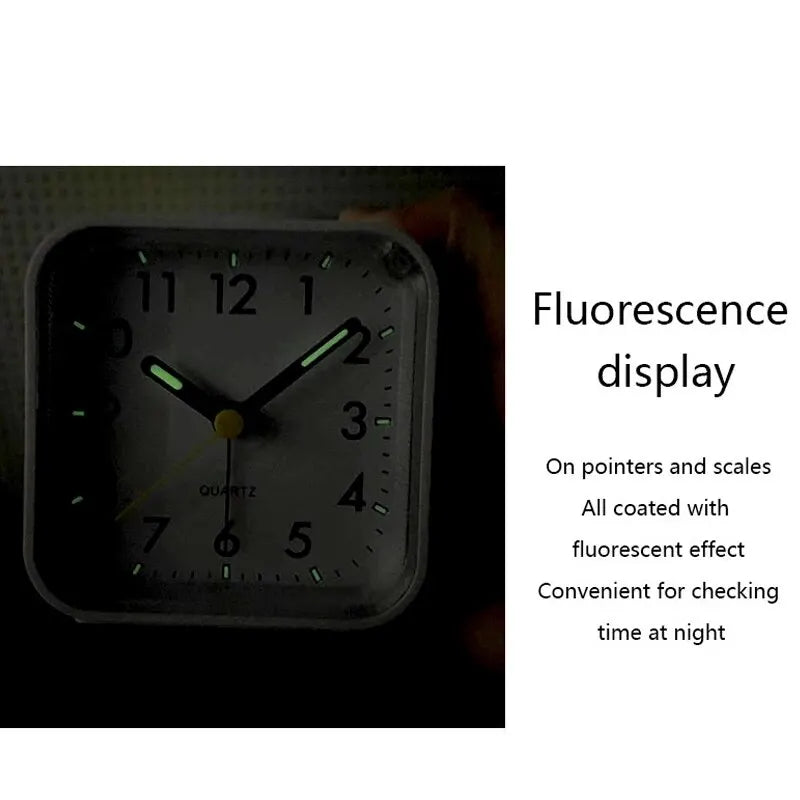 A black digital alarm clock with a fluorescent display showing the time and features for night use.