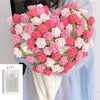 A handmade rose bouquet blanket gift made of pink and red yarn is held against a light blue fabric.