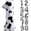 A white foil balloon shaped like the number one with black cow print spots.