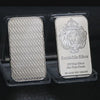 A silver bullion bar replica featuring a crown and lion design is displayed in protective plastic packaging.