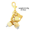A gold-colored dice keychain featuring a lucky charm design and attached to a split ring.