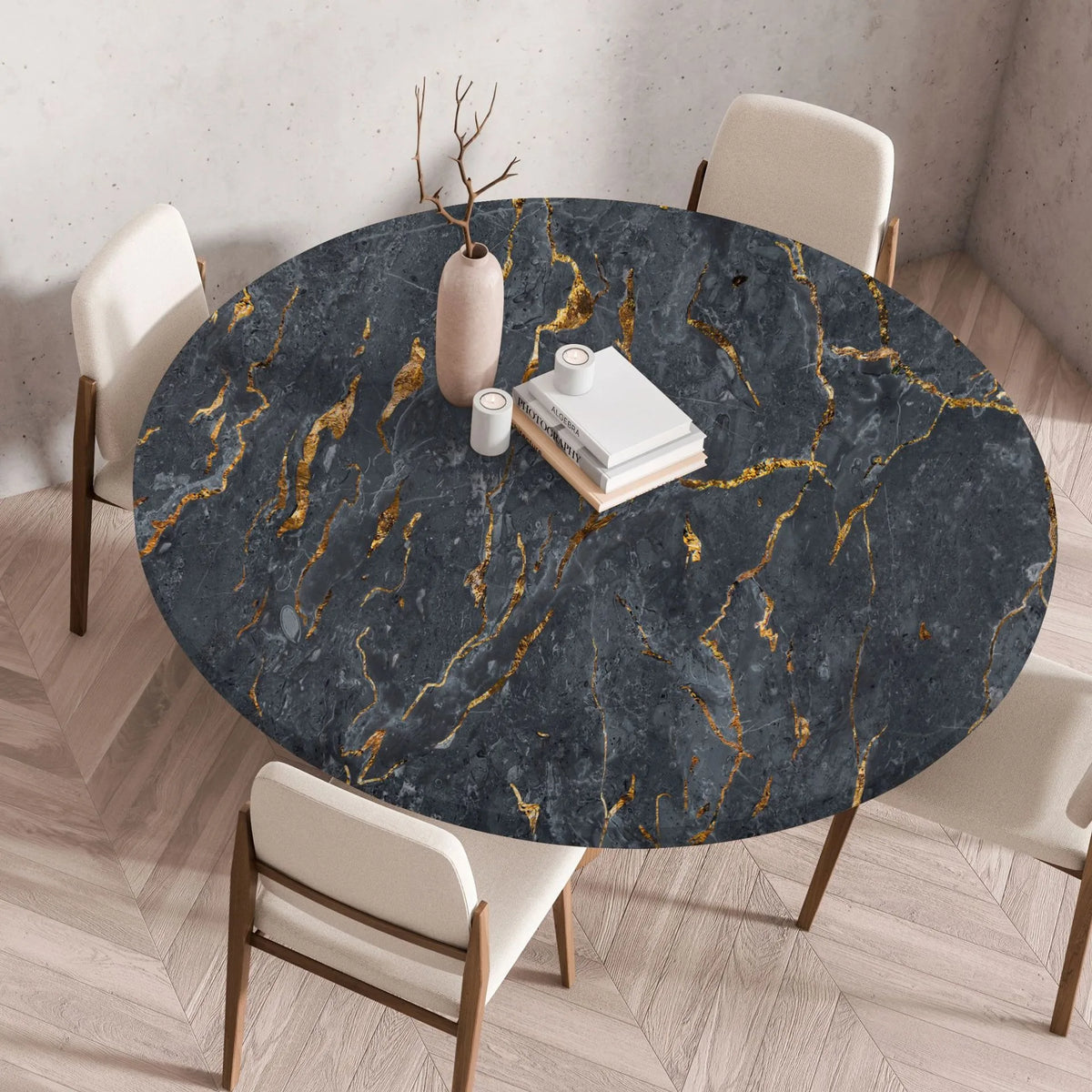A round table covered with a dark gray marble print tablecloth featuring gold veining, set in a modern dining room.
