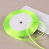 A roll of bright lime green satin ribbon on a white spool, ready for gift wrapping or crafts.