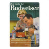 A vintage beer metal sign featuring a couple enjoying a drink in a pub setting.