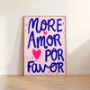 A vertical canvas print featuring the text MORE AMOR POR FAVOR in blue script on a pink background.