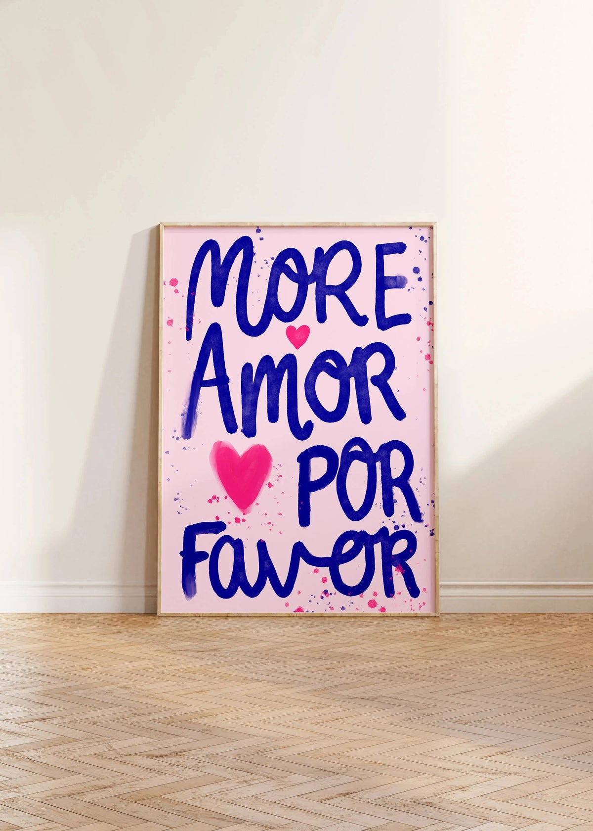 A vertical canvas print featuring the text MORE AMOR POR FAVOR in blue script on a pink background.